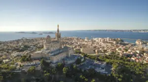 High angle view of cityscape by sea against sky